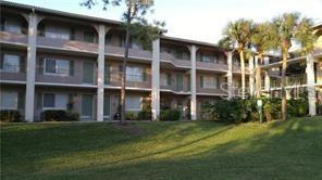 a front view of a building with a garden