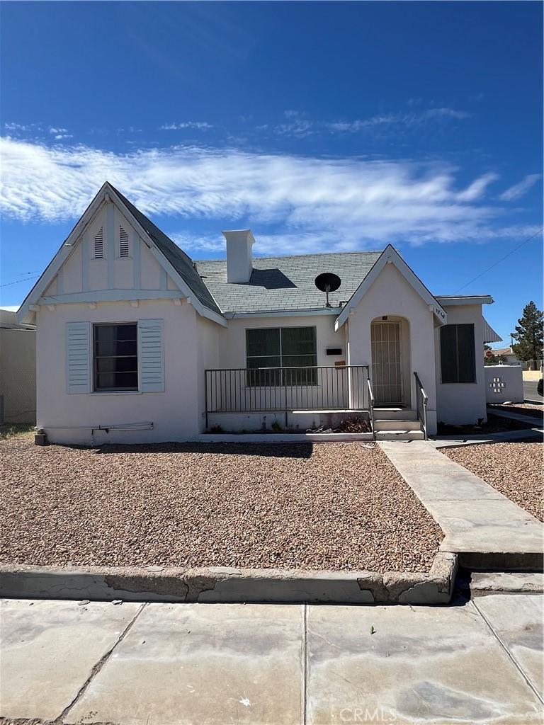 a front view of a house with yard and windows