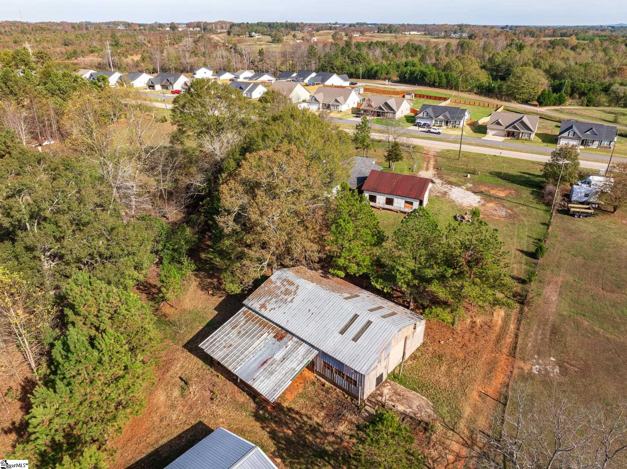 Possibilities abound at this 5.87 acre property with a residential building, 23x34 carport, 40x62 metal building, and smaller 24x30 workshop.  Bring your business or projects, there is plenty of space to work!