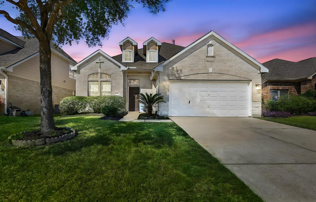 a front view of a house with a yard and garage