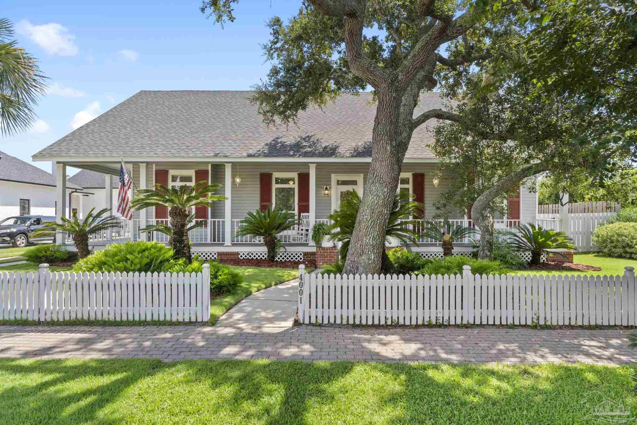 a view of a deck with a fence and trees