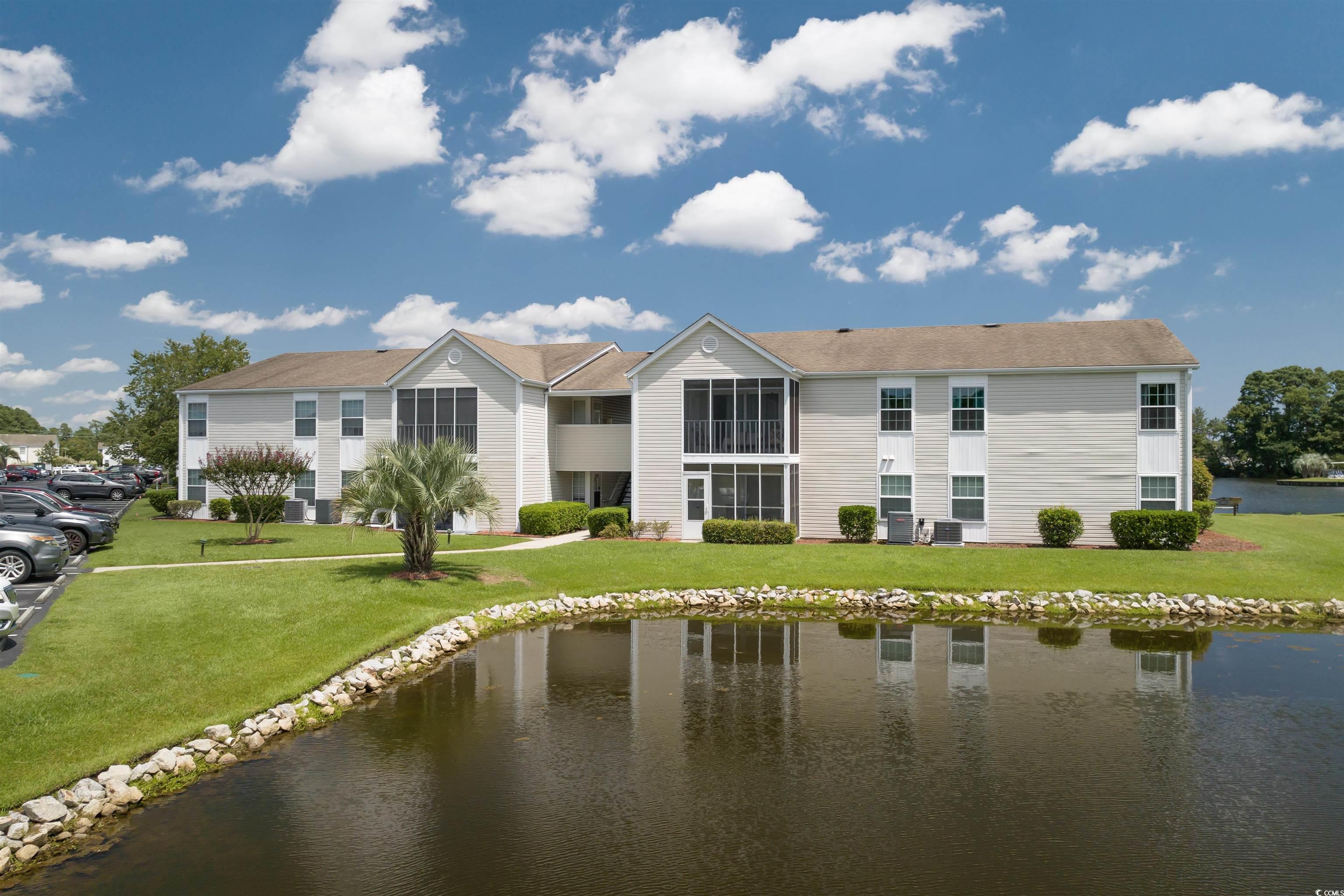 Exterior space featuring a water view and a yard