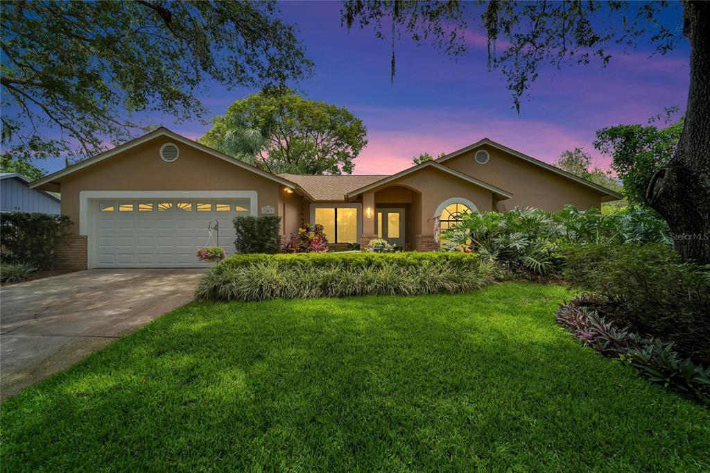 a front view of a house with a garden