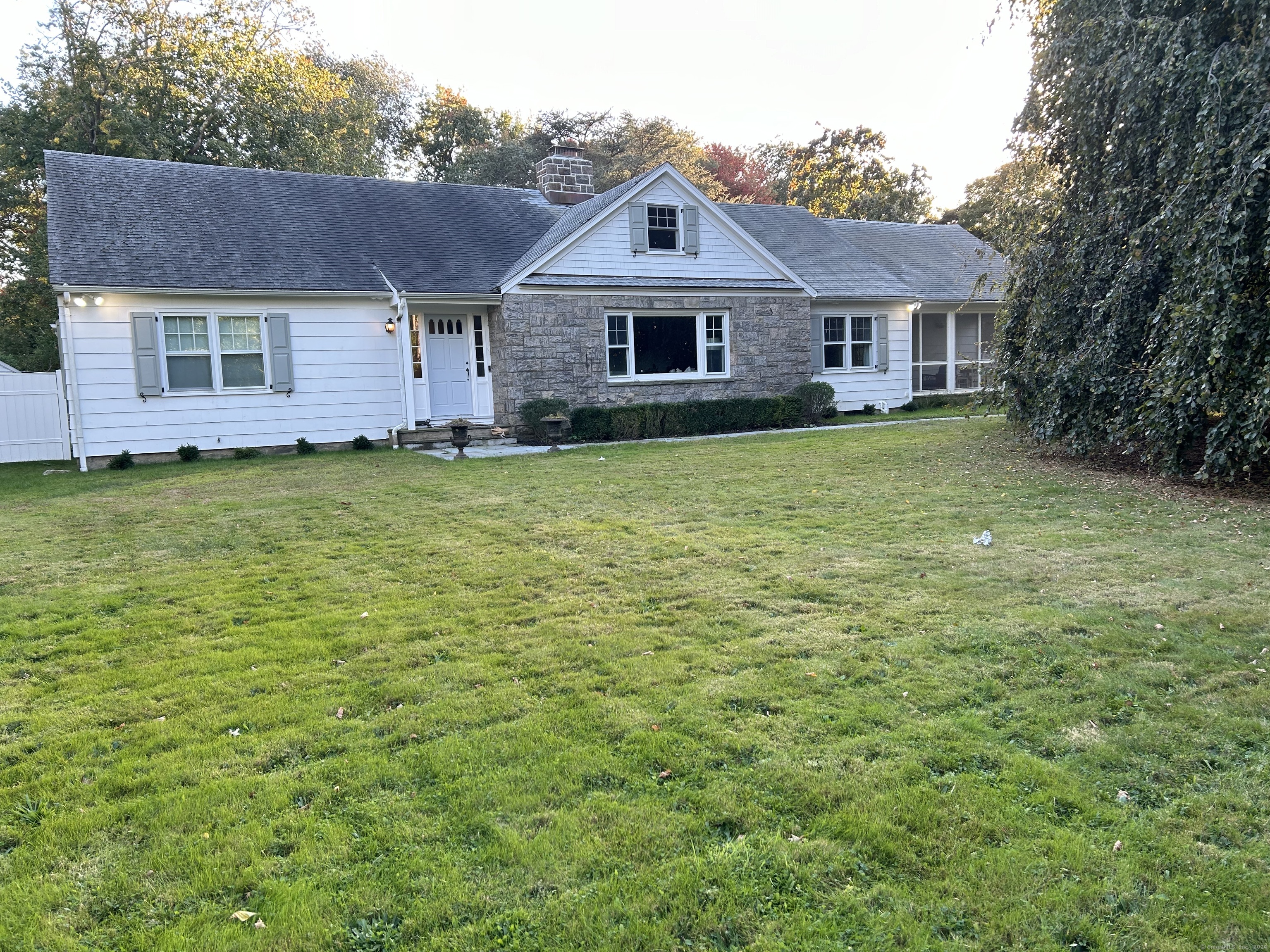 a front view of a house with a garden