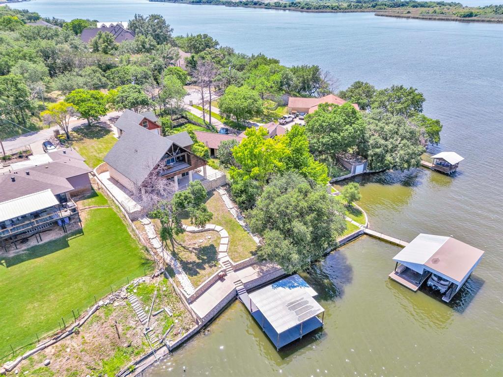 an aerial view of a house with a garden and lake view