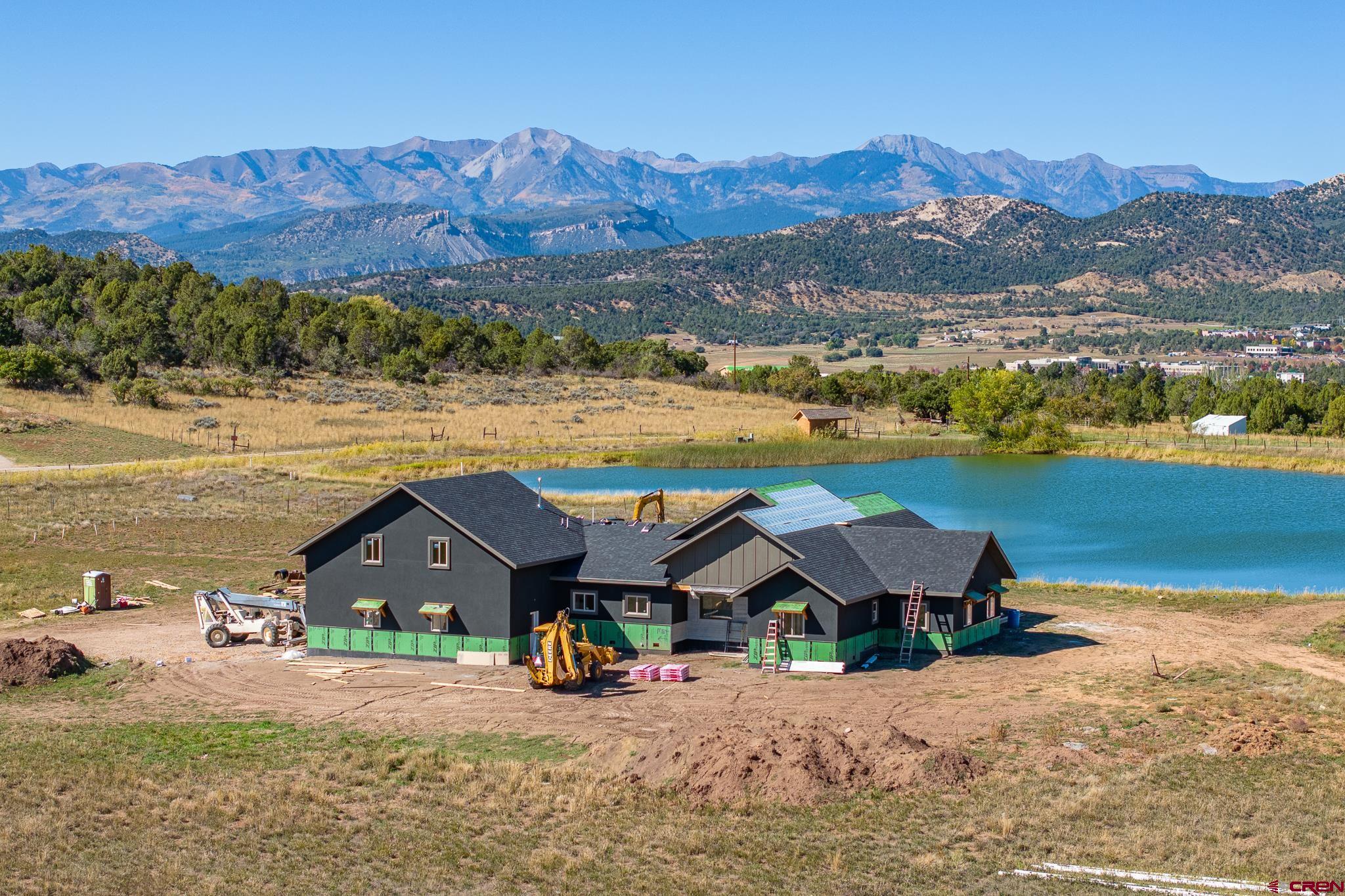 an aerial view of a house with a lake view