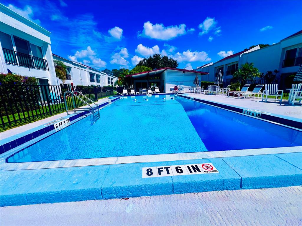 a view of a pool with outdoor seating