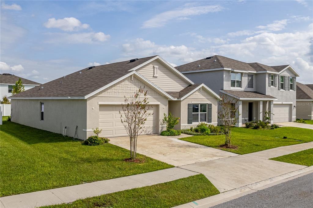 a front view of house with yard and green space