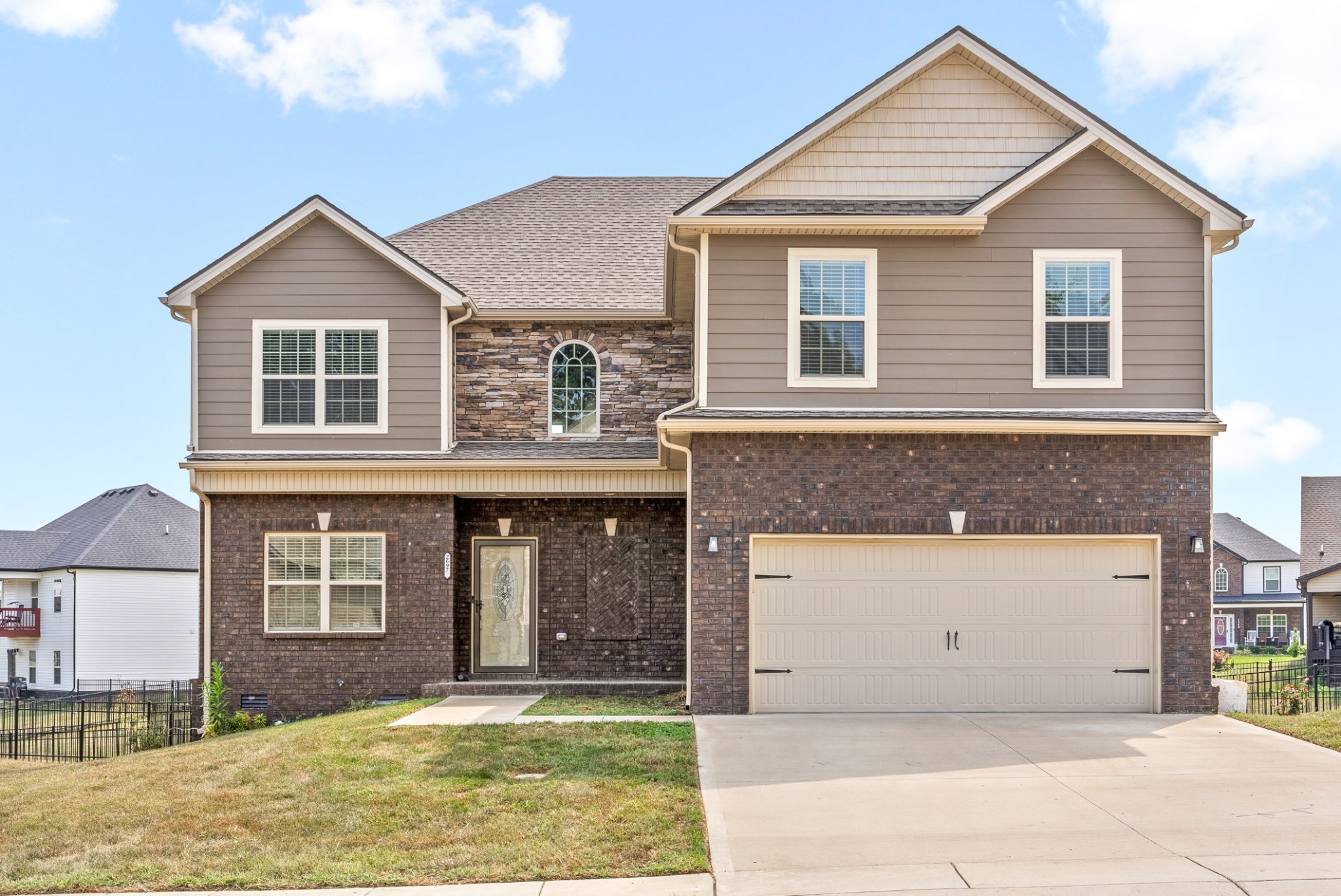 a front view of a house with a yard and garage