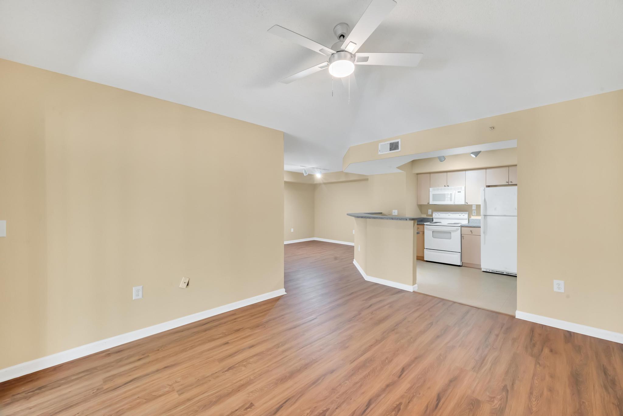 a view of a kitchen with wooden floor and a sink