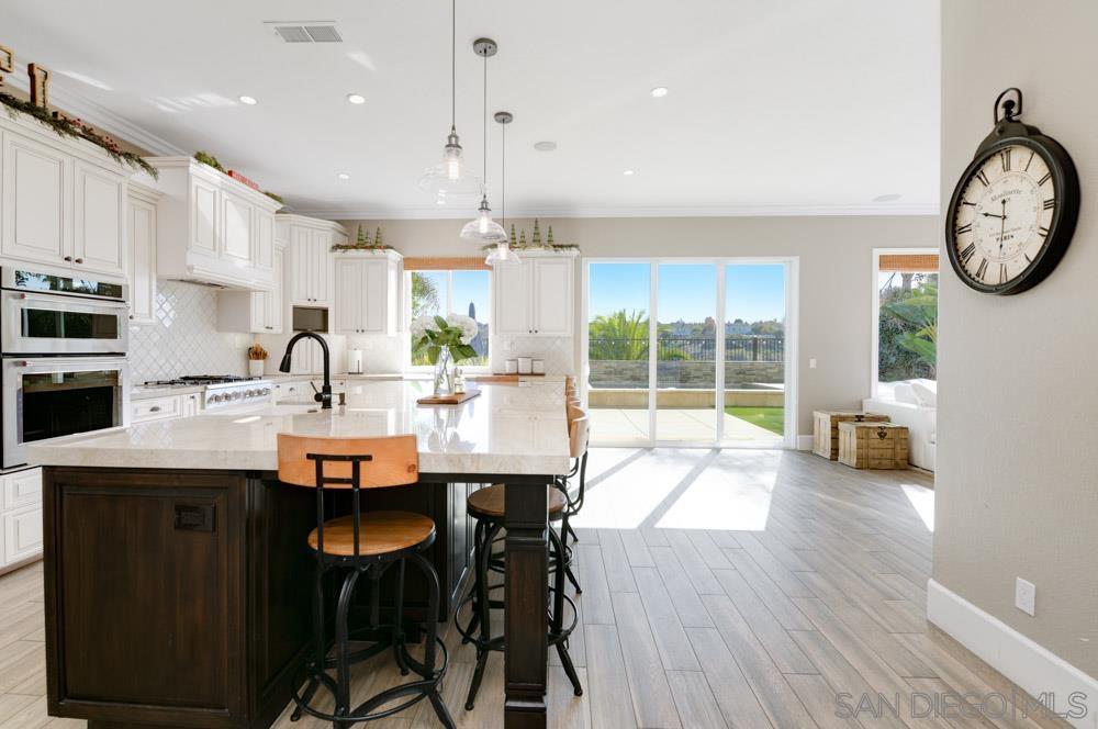 a large kitchen with a table and chairs