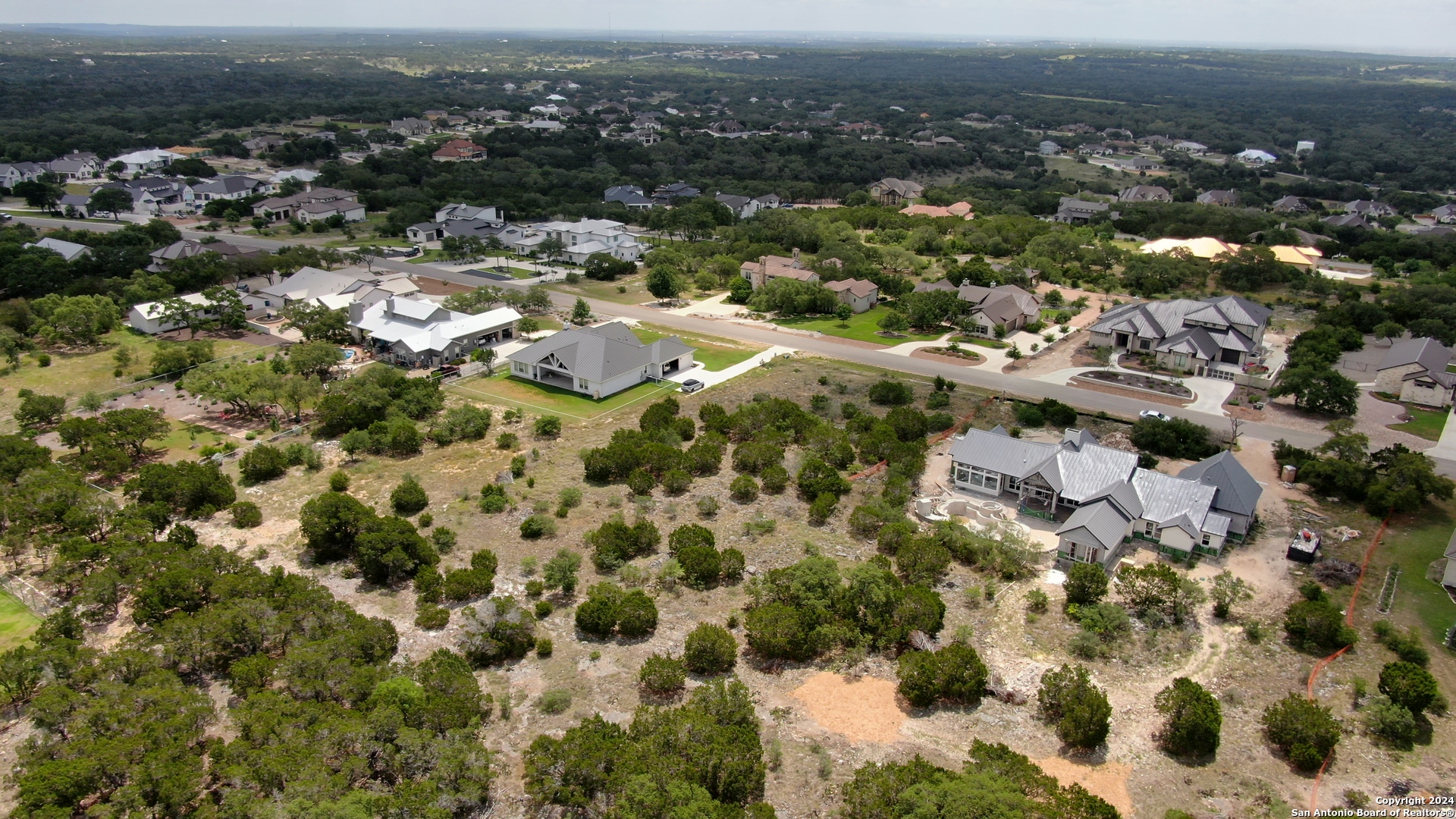 an aerial view of residential houses with city view