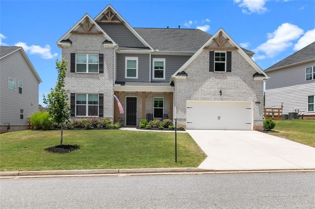 a front view of a house with a yard