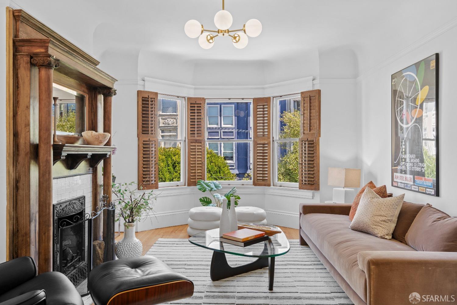 a living room with furniture fireplace and a large window