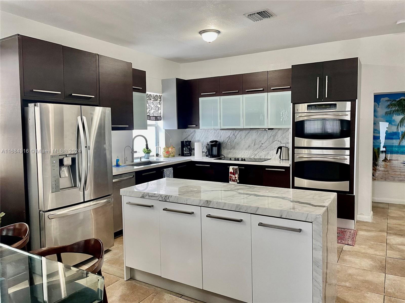 a kitchen with a refrigerator sink and microwave