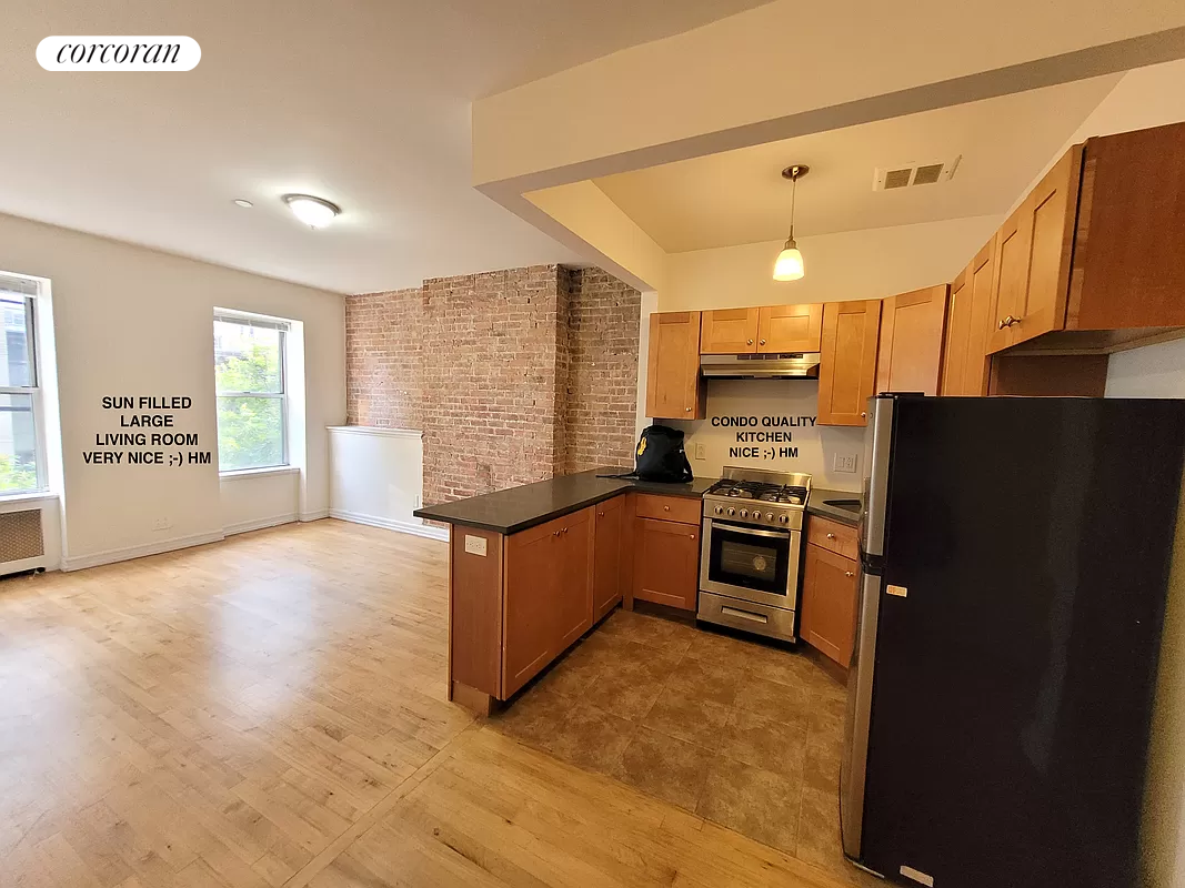 a kitchen with granite countertop a refrigerator and a stove top oven