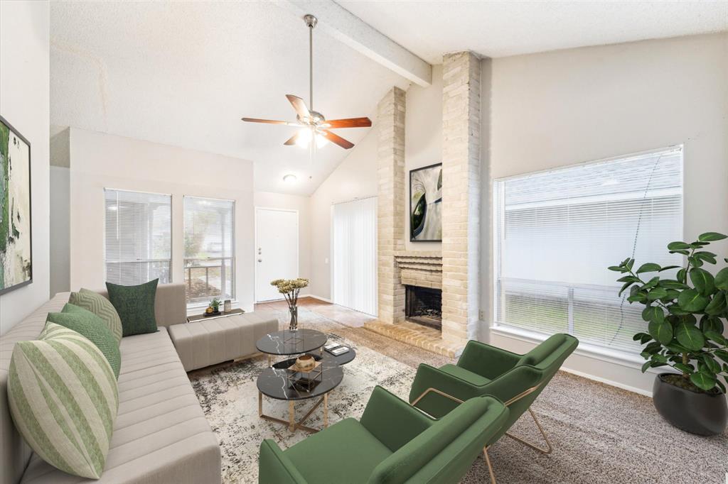 a living room with furniture a fireplace and a potted plant