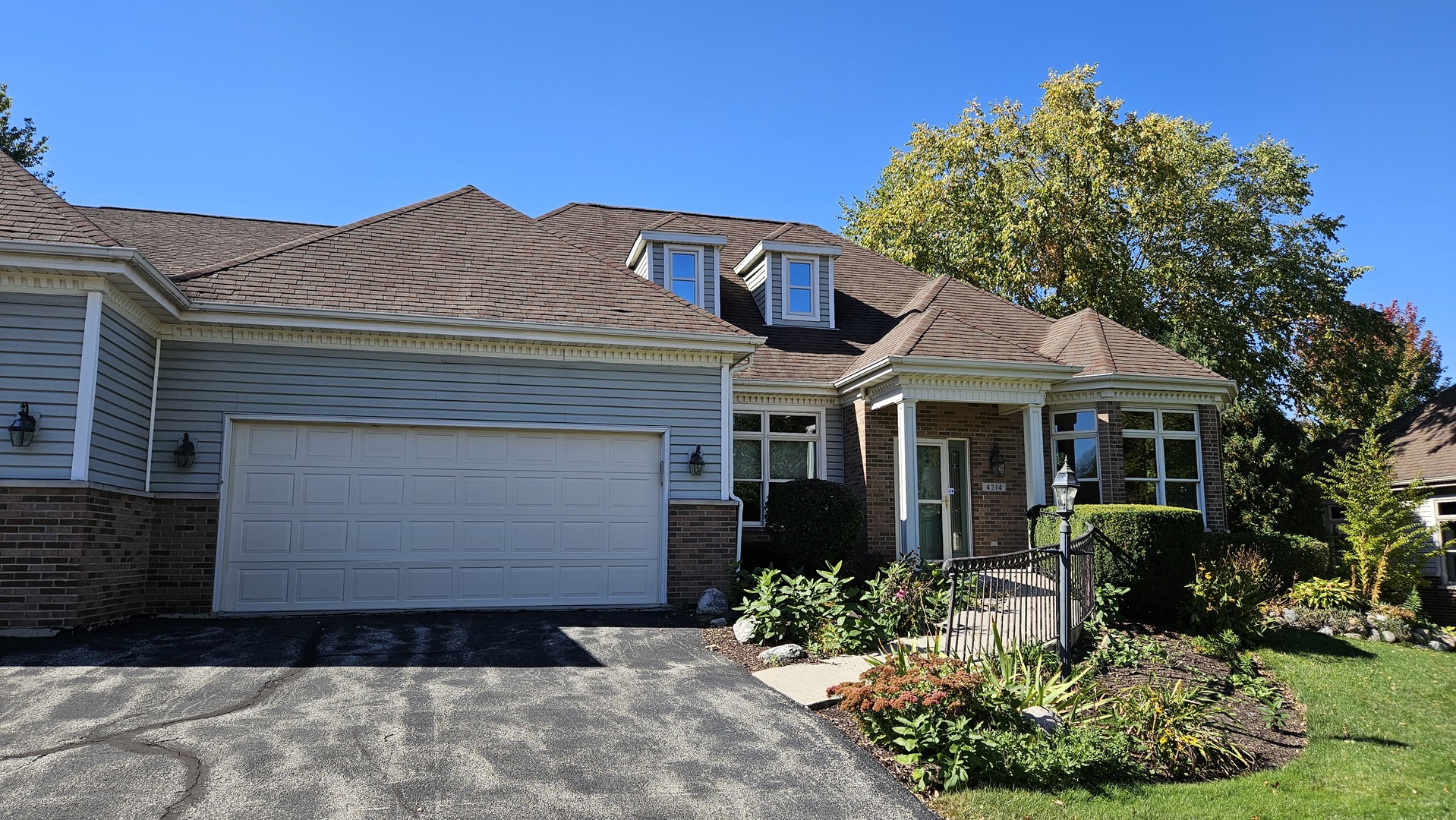 a front view of a house with a garden