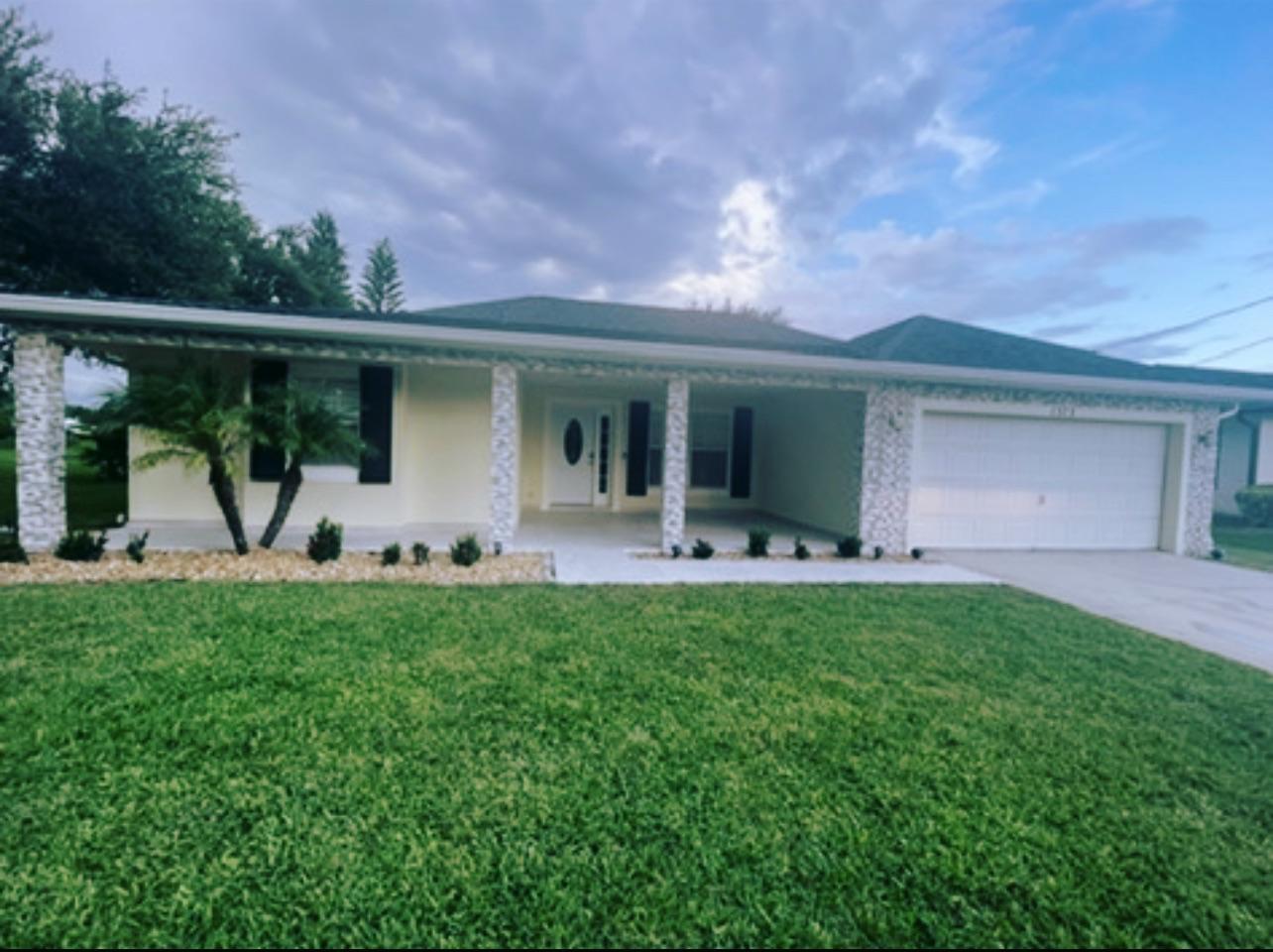 a front view of house with yard and green space