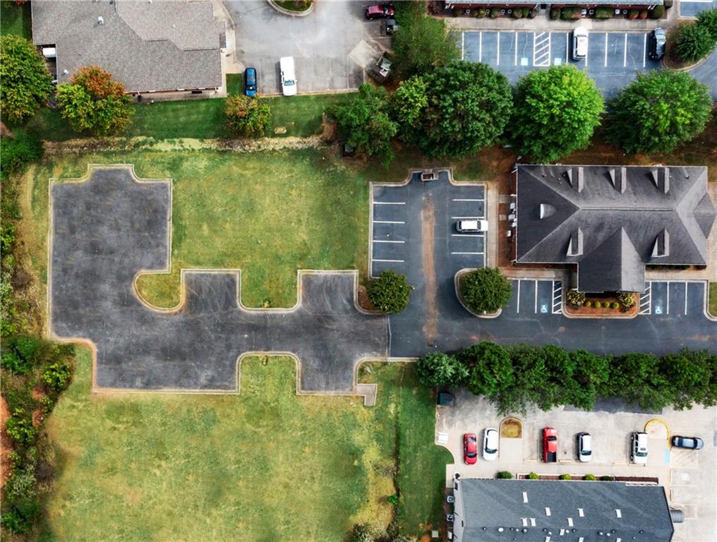 an aerial view of a house with garden space and a lake view in back