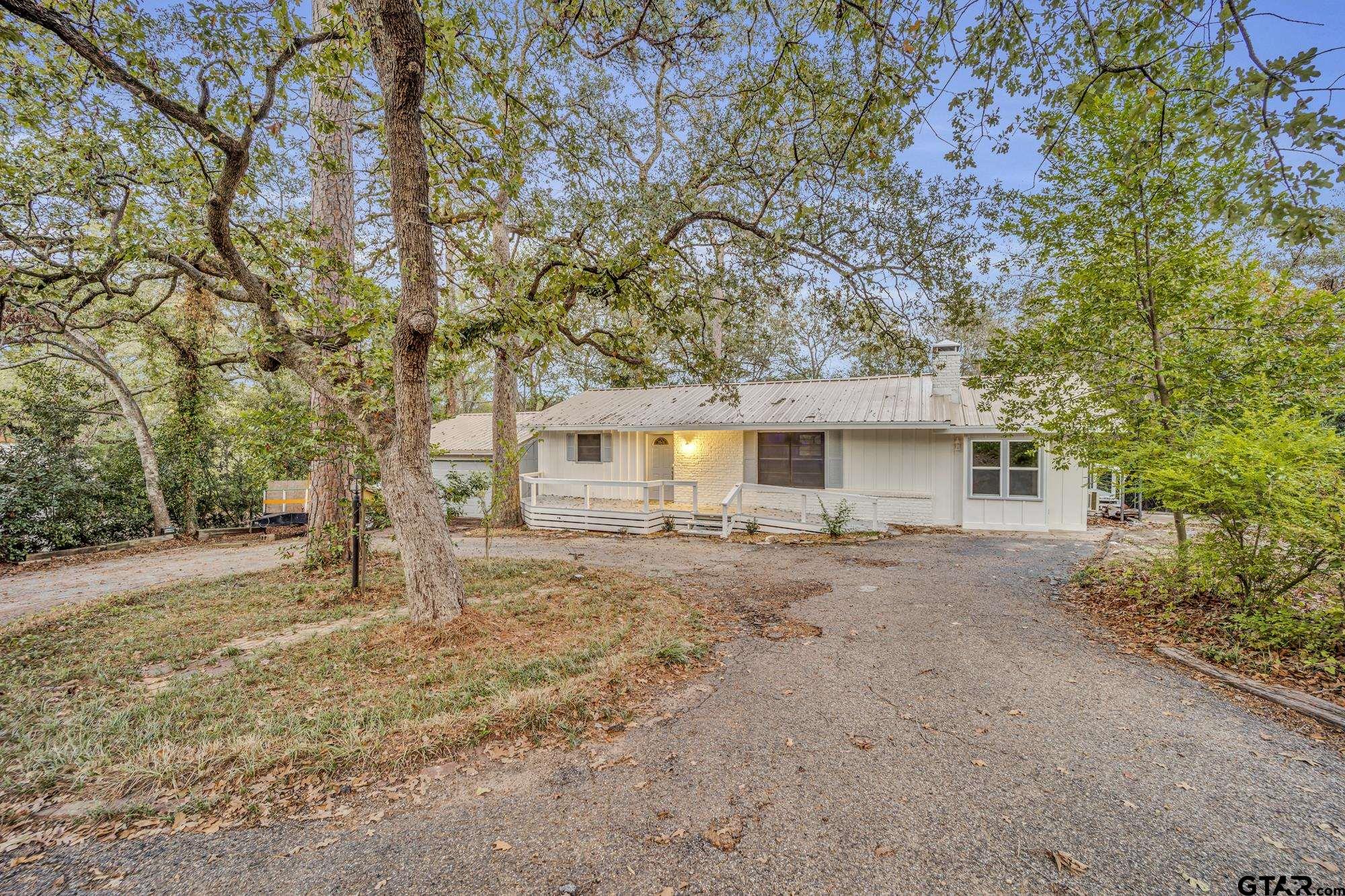 a view of a house with a tree and yard