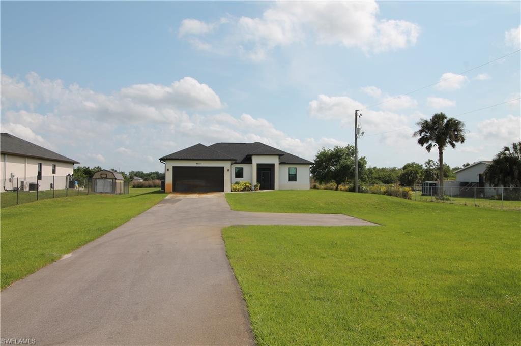 a front view of house with yard and green space