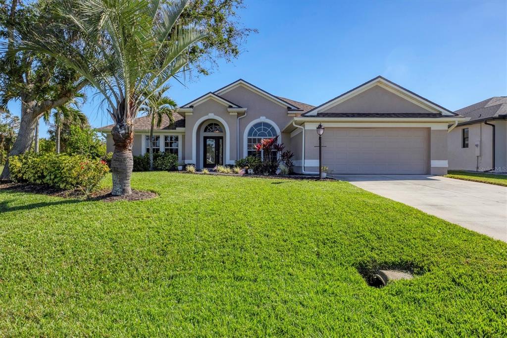 a front view of a house with yard and green space