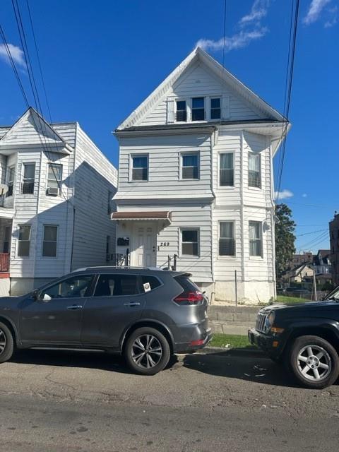 a front view of a house with parking space