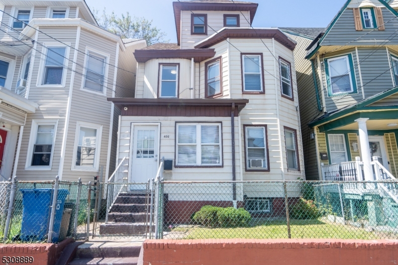 a front view of a residential apartment building with a yard