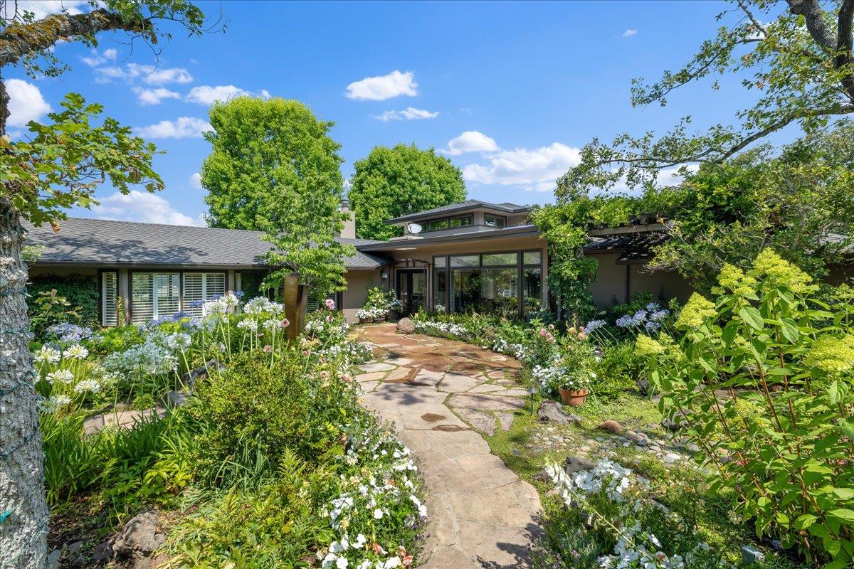 a view of a house with a yard and a garden