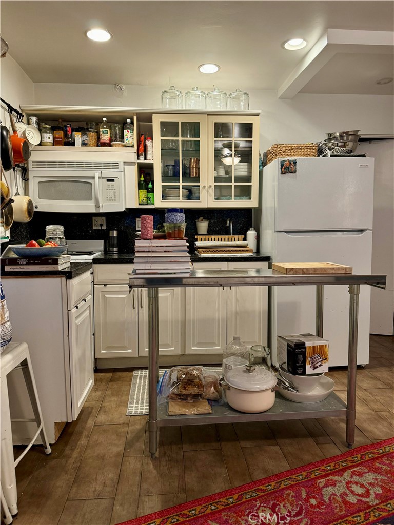 a kitchen with furniture and view of kitchen