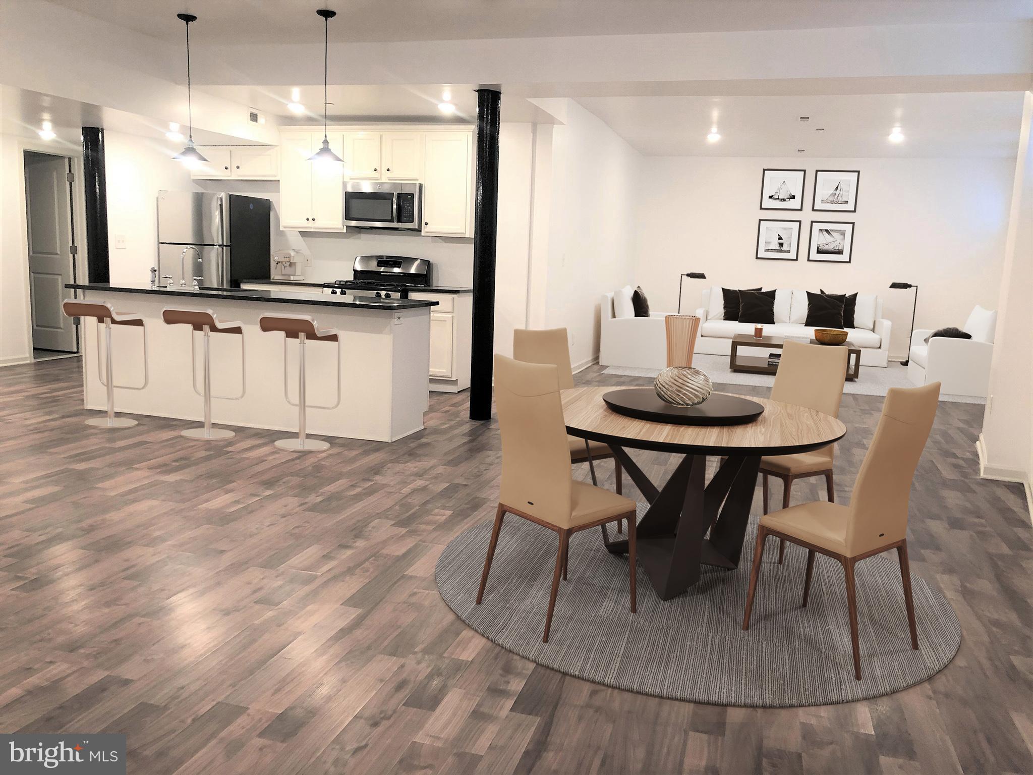 a kitchen with stainless steel appliances kitchen island granite countertop a sink and cabinets