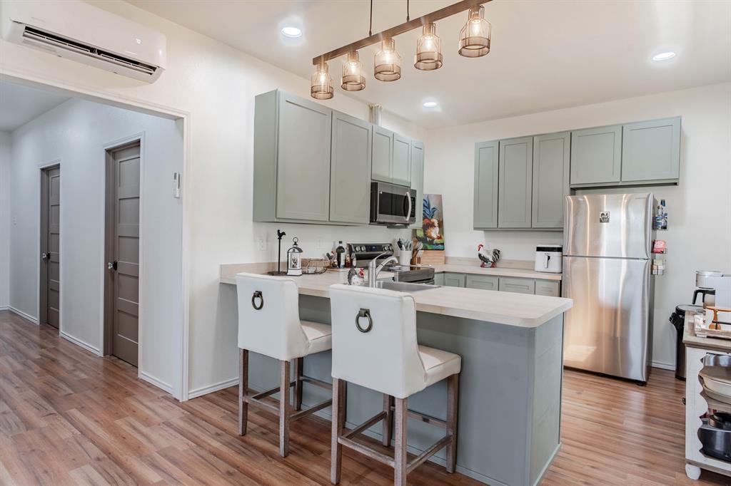 a kitchen with stainless steel appliances a sink stove and refrigerator