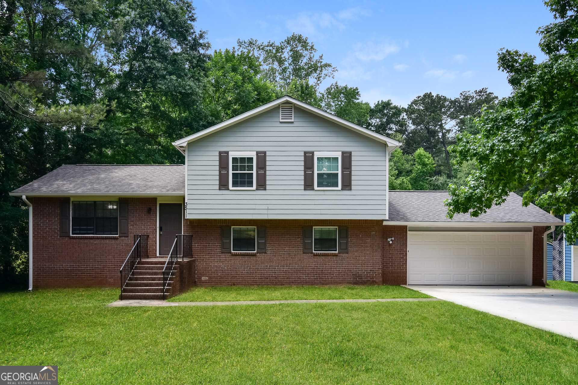 a front view of a house with a yard and garage