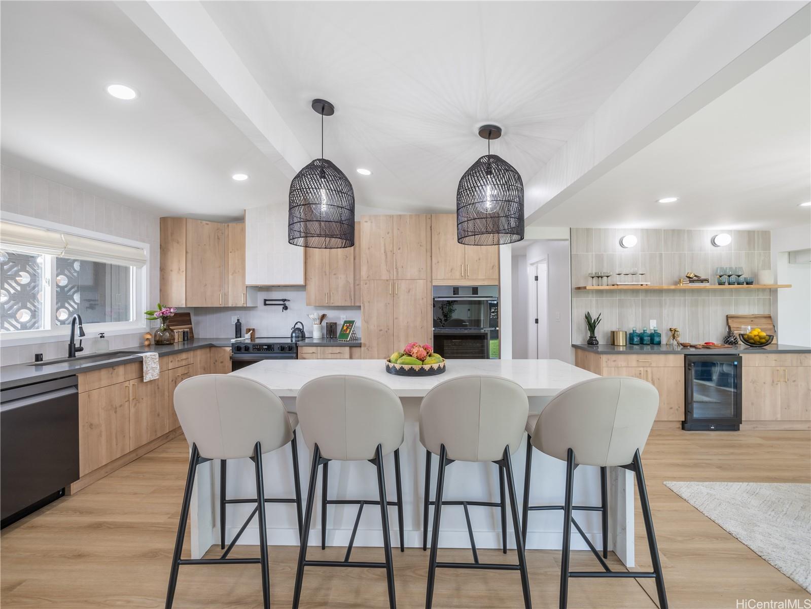 Dream Kitchen with Luxurious Finishes! Custom Lighting, Island Dining with Waterfall Countertops. Impeccable Quality White Oak Kitchen Cabinets show off the Tasteful Design & Functionality of the Space!