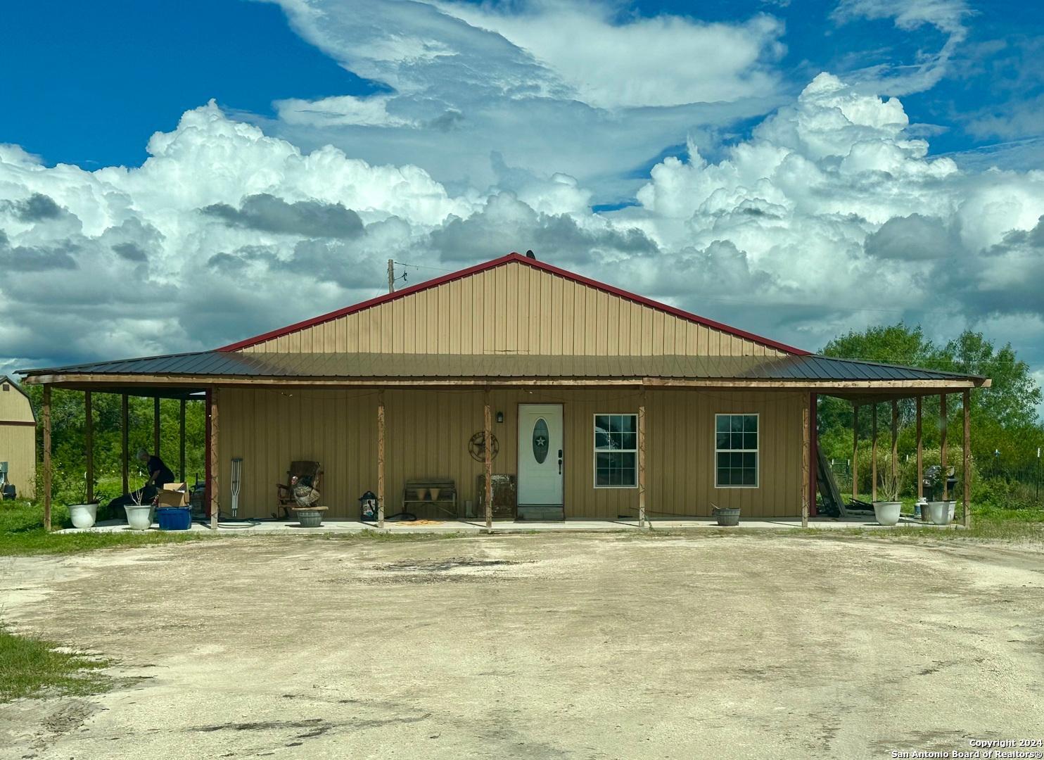 a view of a house with backyard porch and furniture