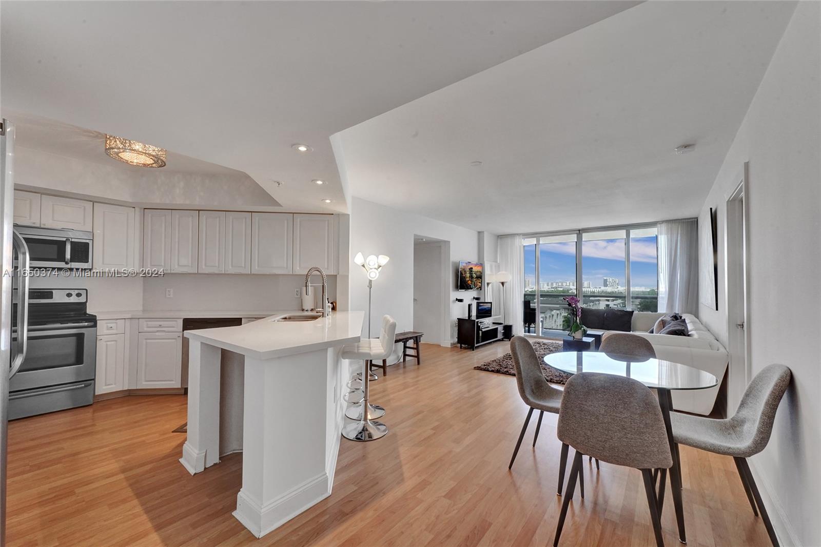 a view of a dining room with furniture and wooden floor