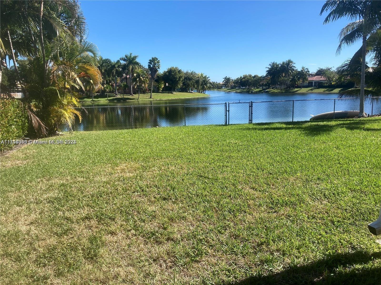 a view of a lake with a house in the background