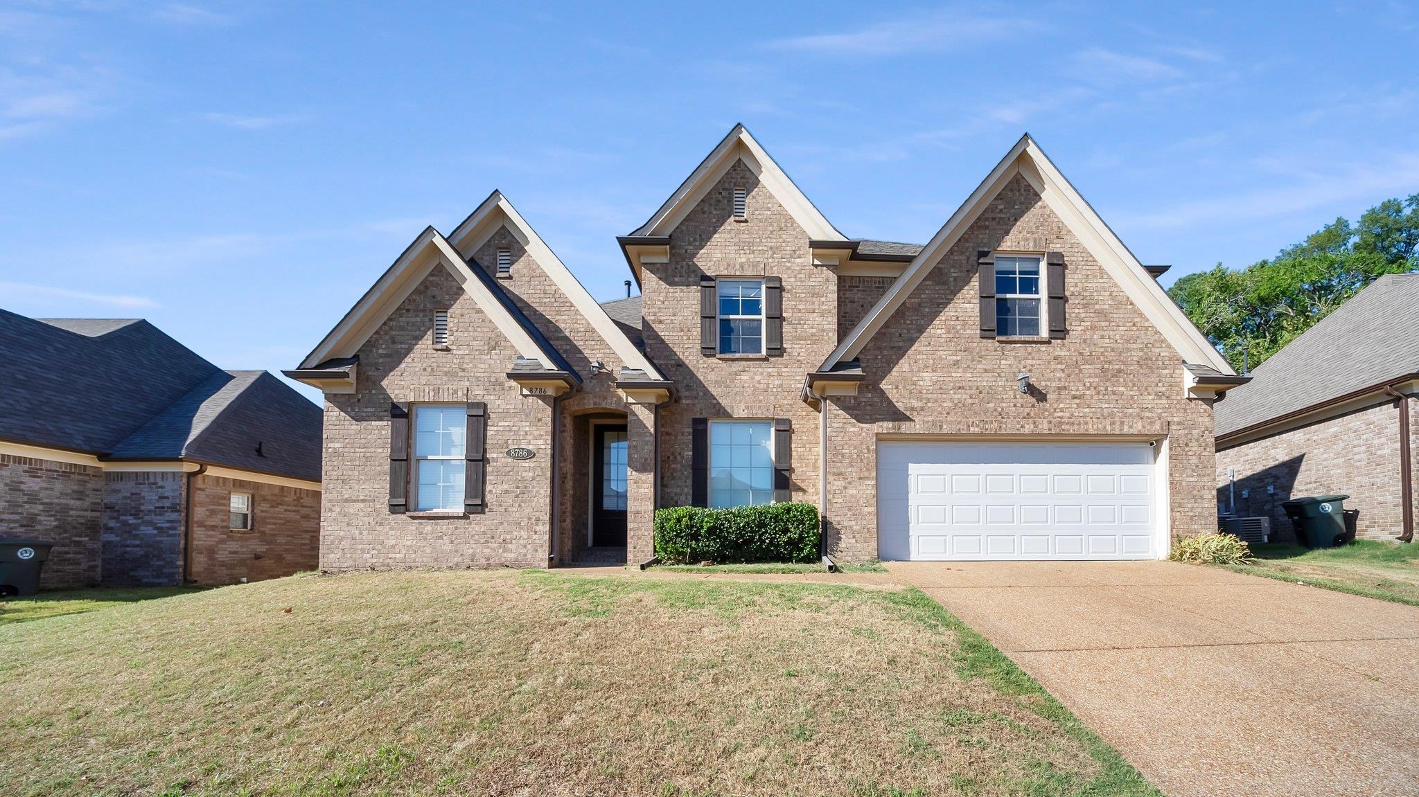 View of front of home featuring a garage and a front yard