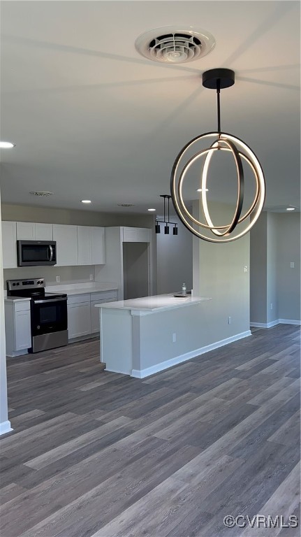 a kitchen with a stove and a wooden floor