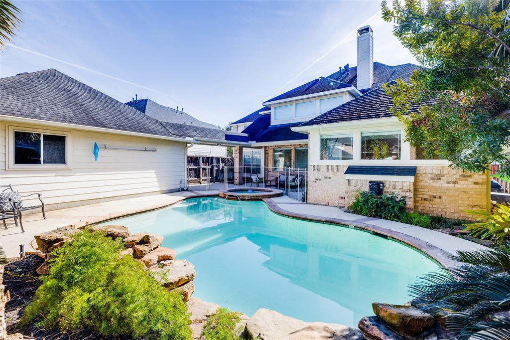 a view of a house with swimming pool and sitting area