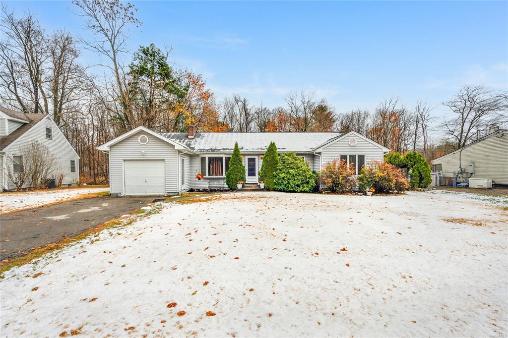 a view of a dry backyard with a house