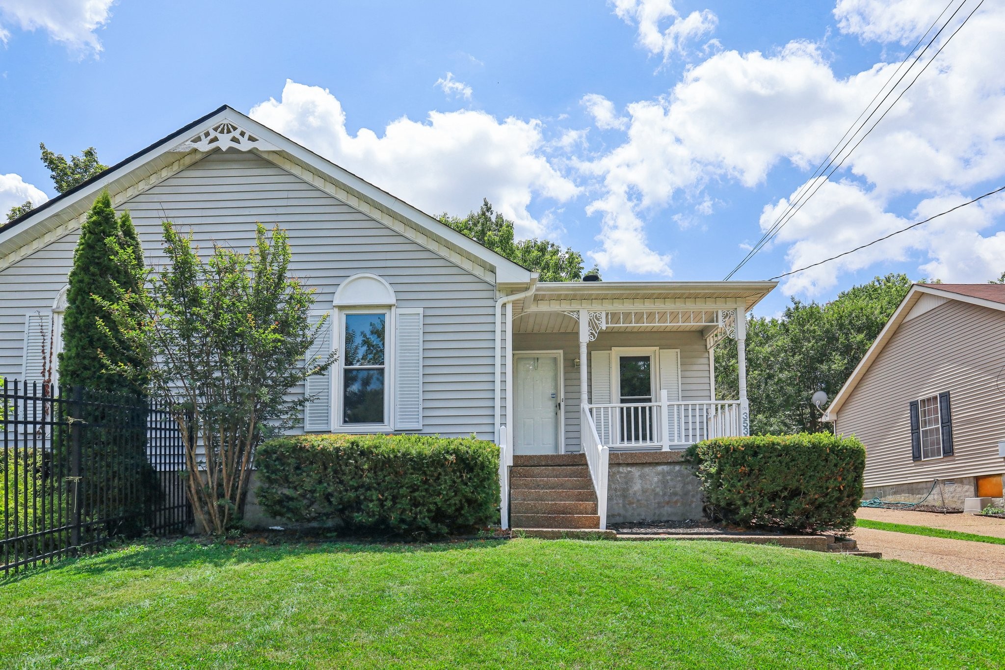 a front view of a house with a garden