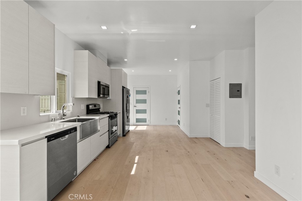 a large kitchen with cabinets and stainless steel appliances