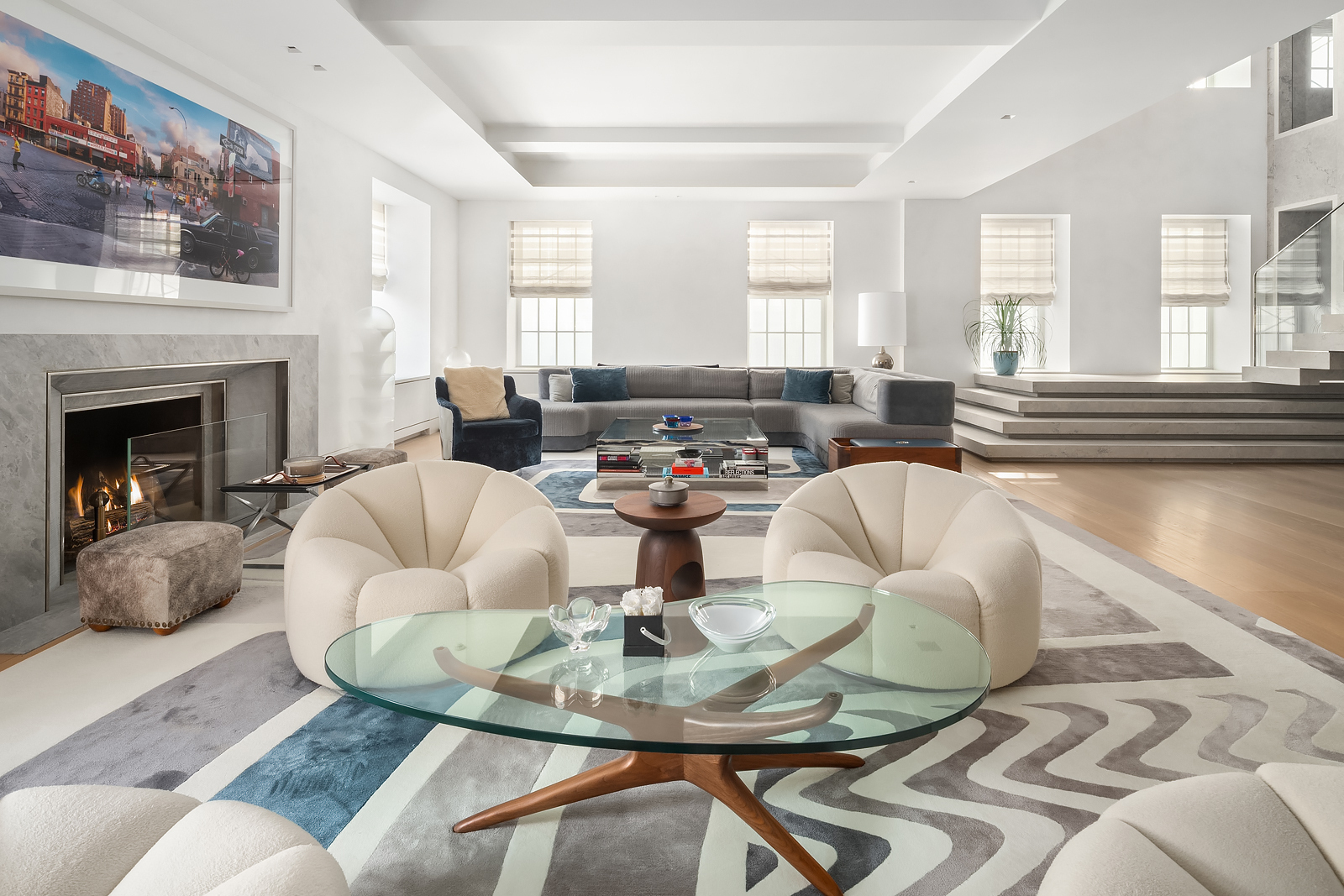 a living room with fireplace furniture and a large window