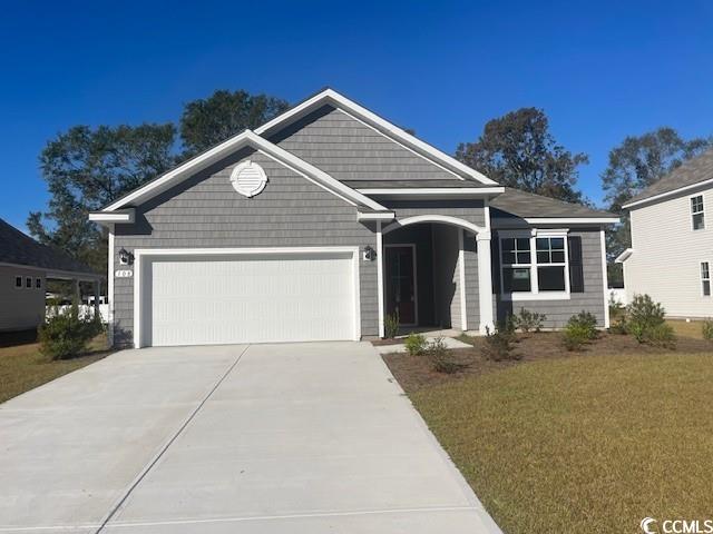 View of front of property with a garage and a fron