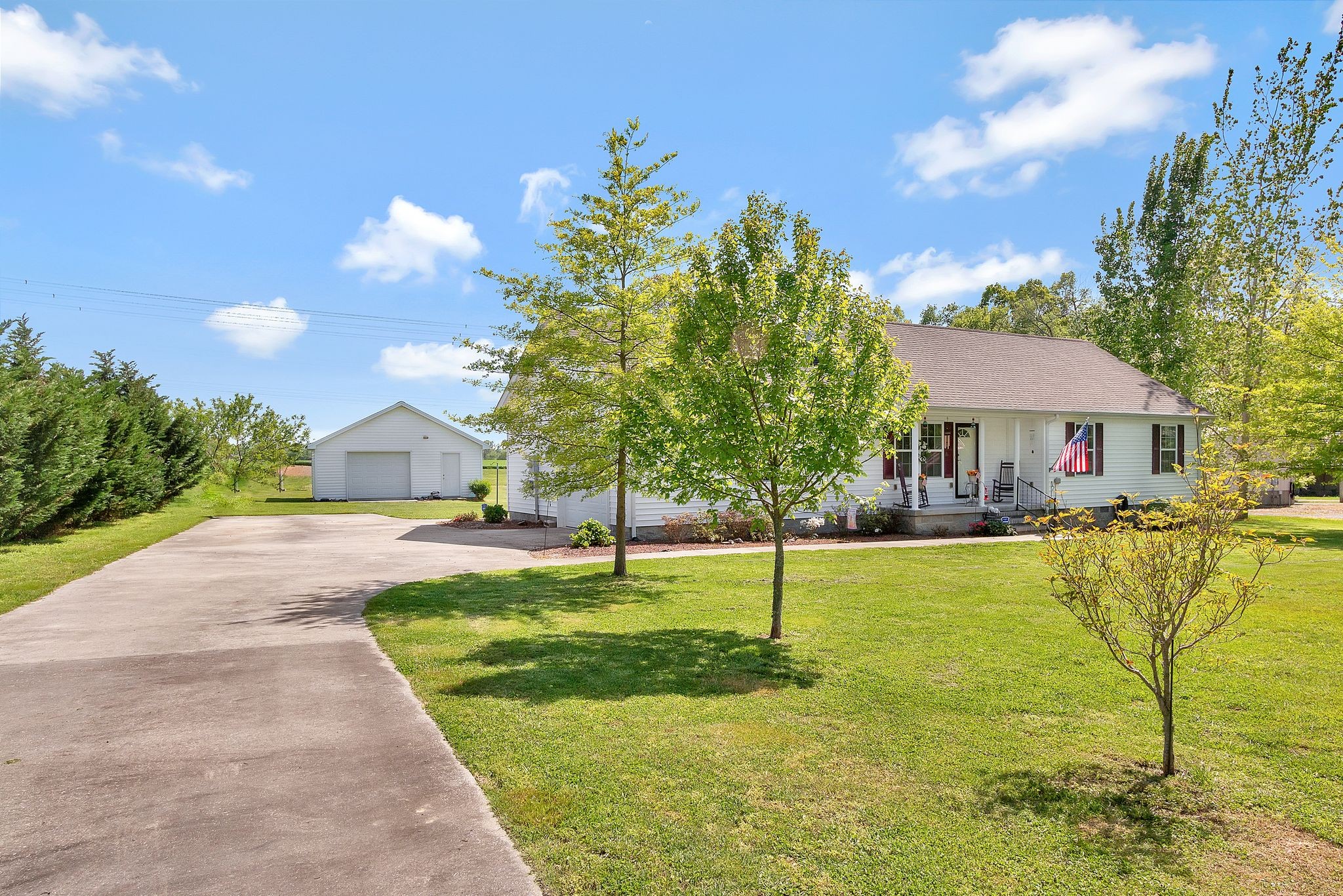 a front view of house with swimming pool and green space