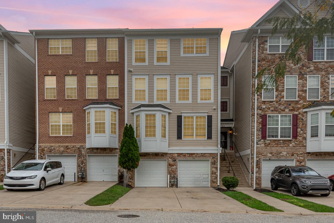 a front view of a residential apartment building with a yard