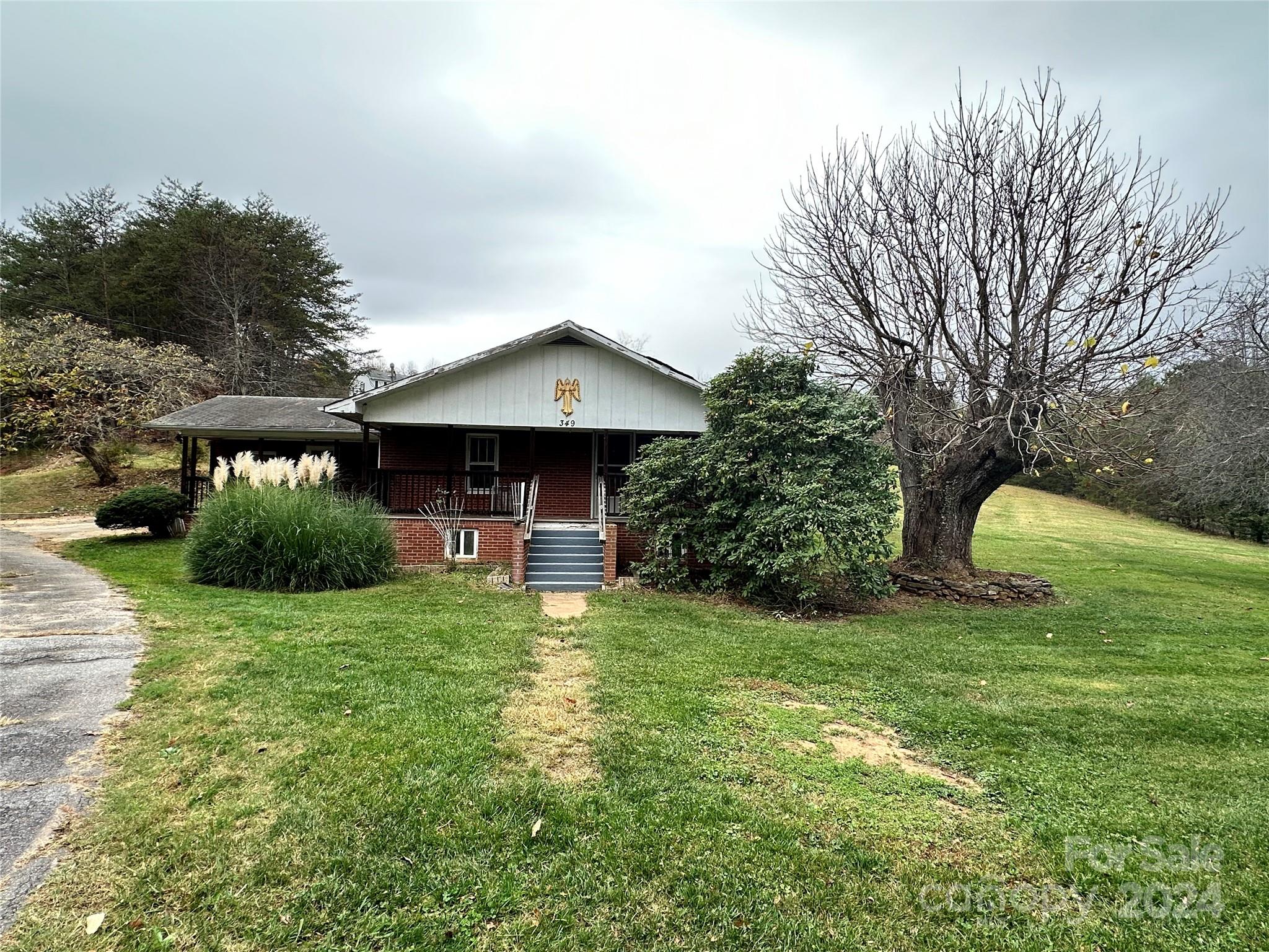 a view of a house with a yard and sitting area