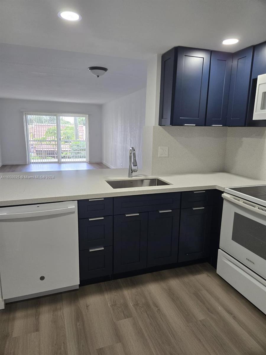 a kitchen with a sink and wooden cabinets